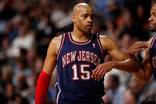 New Jersey Nets guard Vince Carter confers with teammates while facing the Denver Nuggets in the third quarter of the Nuggets' 121-96 victory in an NBA basketball game in Denver on Monday, March 16, 2009. (AP Photo/David Zalubowski)