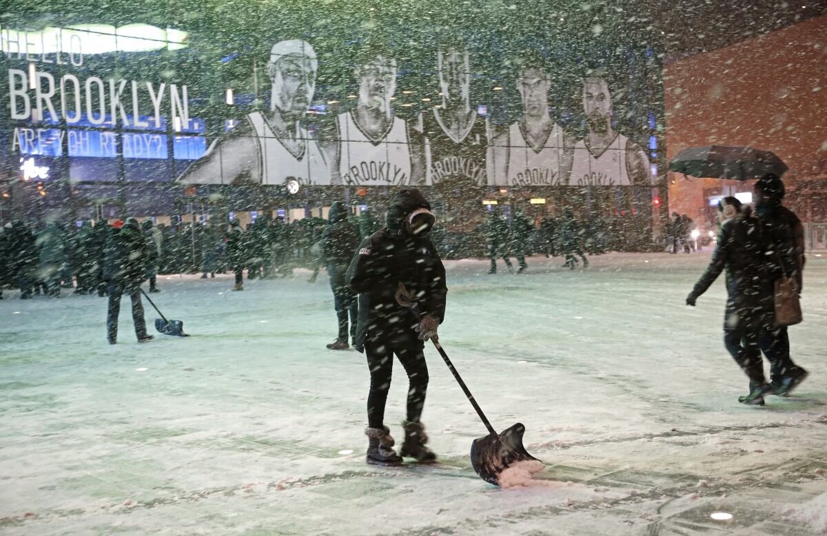 Workers shovel snow outside Barclays Center on January 21, 2014. (AP)