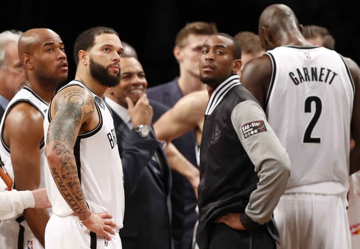 The Nets look on in the waning moments of their triple-OT loss. (AP)