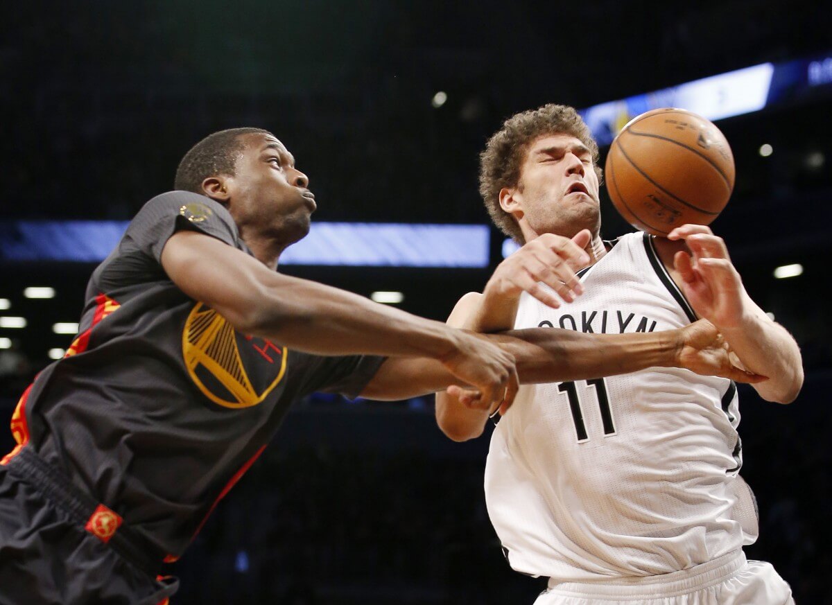Golden State Warriors forward Harrison Barnes, left, loses the ball to Brooklyn Nets center Brook Lopez (11) who bobbles it beneath the Warriors basket in the first half of an NBA basketball game at the Barclays Center, Monday, March 2, 2015, in New York. (AP Photo/Kathy Willens)