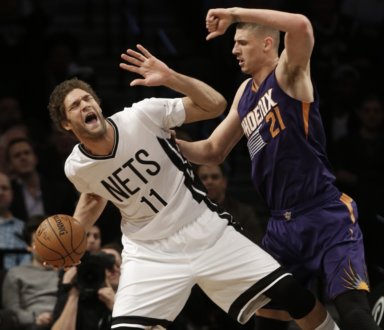 Phoenix Suns' Alex Len (21), of Ukraine, defends against Brooklyn Nets' Brook Lopez (11) during the first half of an NBA basketball game Friday, March 6, 2015, in New York. (AP Photo/Frank Franklin II)