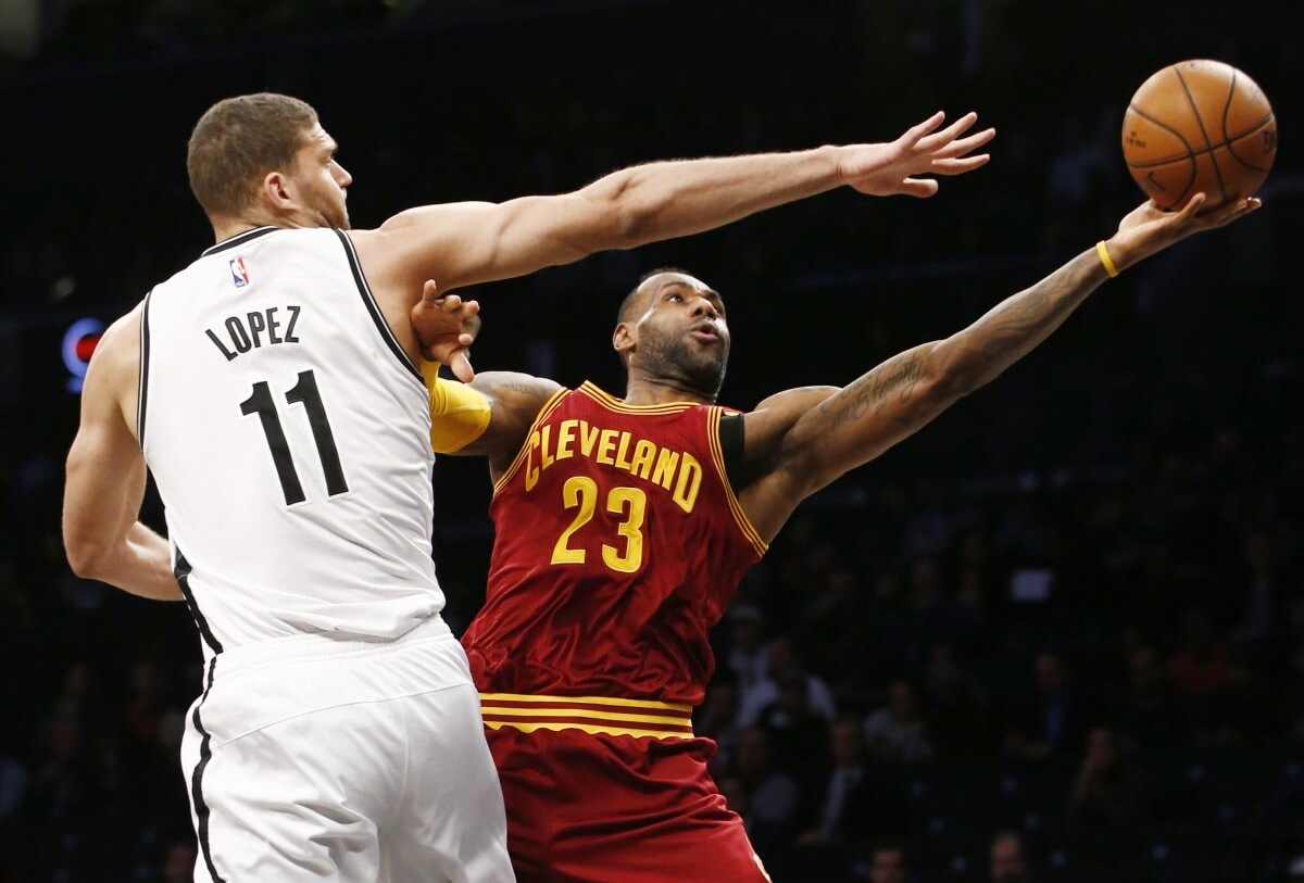 Brooklyn Nets center Brook Lopez (11) defends Cleveland Cavaliers forward LeBron James (23) in the first half of an NBA basketball game, Wednesday, Jan. 20, 2016, in New York. (AP Photo/Kathy Willens)
