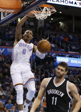 Russell Westbrook dunks over Brook Lopez during the third quarter. (AP Photo/Sue Ogrocki)