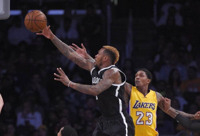 Brooklyn Nets guard Sean Kilpatrick, left shoots as Los Angeles Lakers guard Lou Williams defends during the first half of an NBA basketball game, Tuesday, March 1, 2016, in Los Angeles. (AP Photo/Mark J. Terrill)