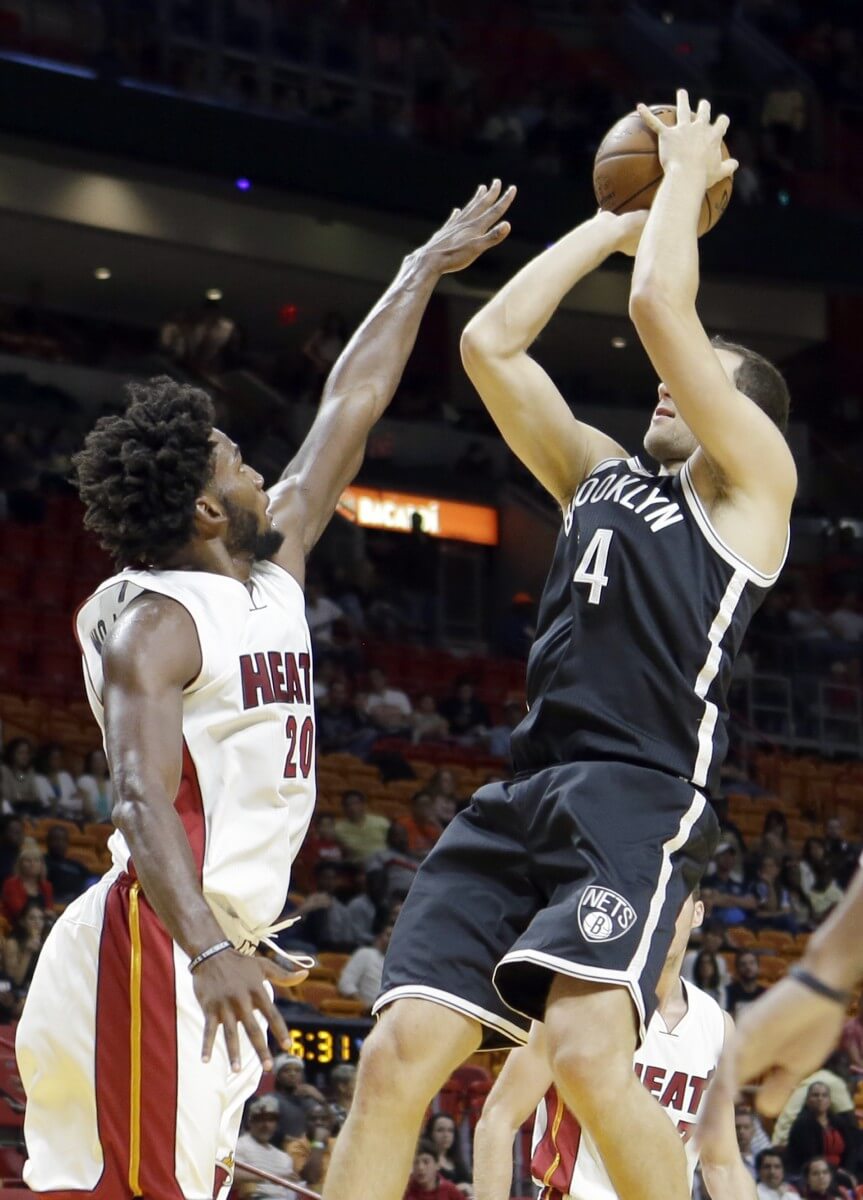 Brooklyn Nets guard Bojan Bogdanovic, right, prepares to shoot over Miami Heat forward Justise Winslow (20) during the first half of an NBA preseason basketball game, Tuesday, Oct. 11, 2016, in Miami. (AP Photo/Alan Diaz)