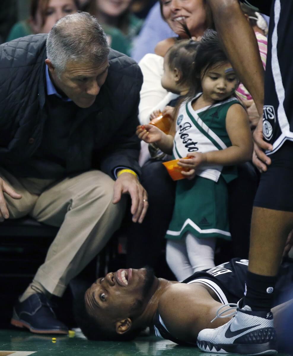 Brooklyn Nets' Thaddeus Young lies on the ground after going out of bounds during the third quarter of an NBA basketball game against the Boston Celtics in Boston, Saturday, Jan. 2, 2016. The Nets won 100-97. (AP Photo/Michael Dwyer)