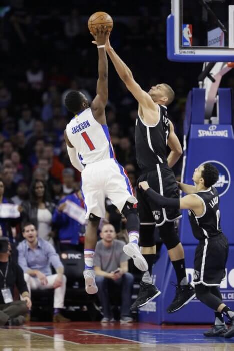 Brooklyn Nets center Brook Lopez blocks a shot by Detroit Pistons guard Reggie Jackson (1) during the first half of an NBA basketball game, Saturday, Jan. 9, 2016 in Auburn Hills, Mich. (AP Photo/Carlos Osorio)
