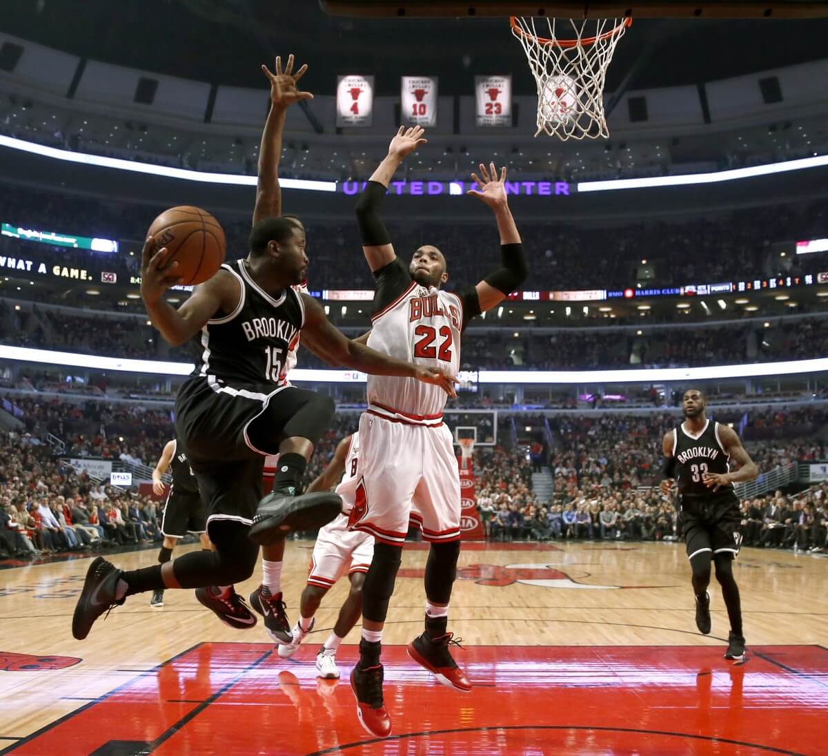 Brooklyn Nets guard Donald Sloan (15) looks to pass the ball past Chicago Bulls forward Taj Gibson (22) during the second half of an NBA basketball game Monday, Dec. 21, 2015, in Chicago. The Nets won 105-102. (AP Photo/Charles Rex Arbogast)