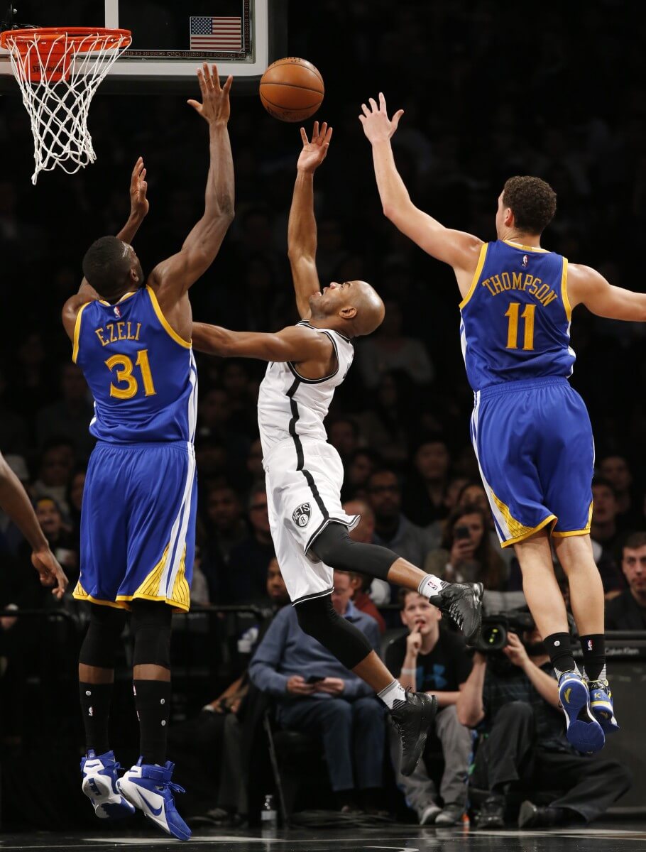 Golden State Warriors center Festus Ezeli (31) and Golden State Warriors guard Klay Thompson (11) defend Jarrett Jack in the first half. (AP Photo/Kathy Willens)