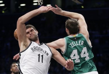 Brook Lopez blocks a shot by Boston Celtics center Tyler Zeller during the third quarter. (AP Photo/Julie Jacobson)