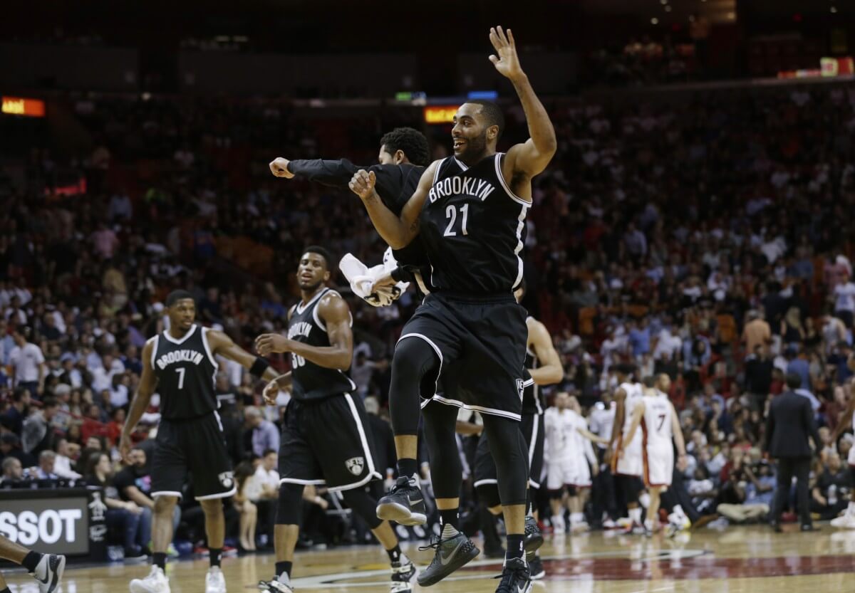Brooklyn Nets' Wayne Ellington (21) celebrates with a teammate after shooting a three-pointer during the second half of an NBA basketball game against the Miami Heat, Monday, Dec. 28, 2015, in Miami. The Nets defeated the Heat 111-105. (AP Photo/Lynne Sladky)