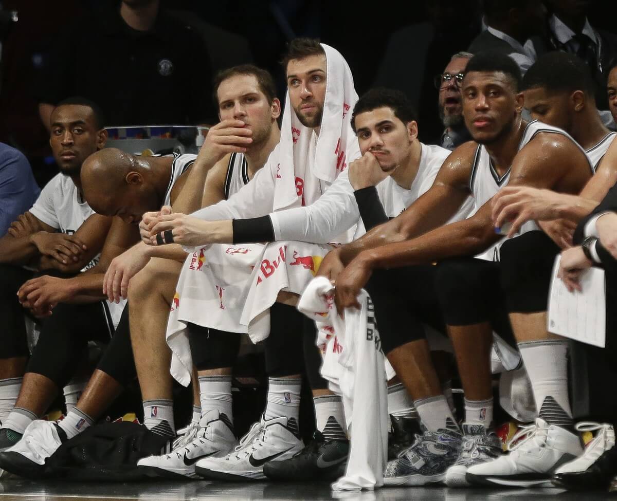 Thaddeus Young, right, Shane Larkin, second from right, Andrea Bargnani, center, and Bojan Bogdanovic, second from left, watch the game during the second half. (AP Photo/Frank Franklin II)