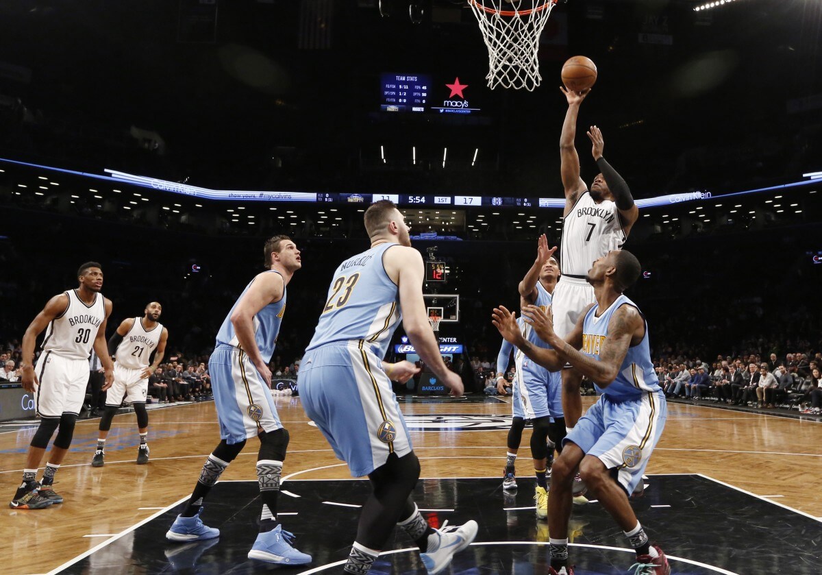 Denver Nuggets defenders, including Nuggets forward Danilo Gallinari (8), Nuggets center Jusuf Nurkic (23) and others defend Brooklyn Nets forward Joe Johnson (7) in the first half of an NBA basketball game, Monday, Feb. 8, 2016, in New York. The Nets defeated the Nuggets 105-104 on Johnson's three-point buzzer beater. (AP Photo/Kathy Willens)