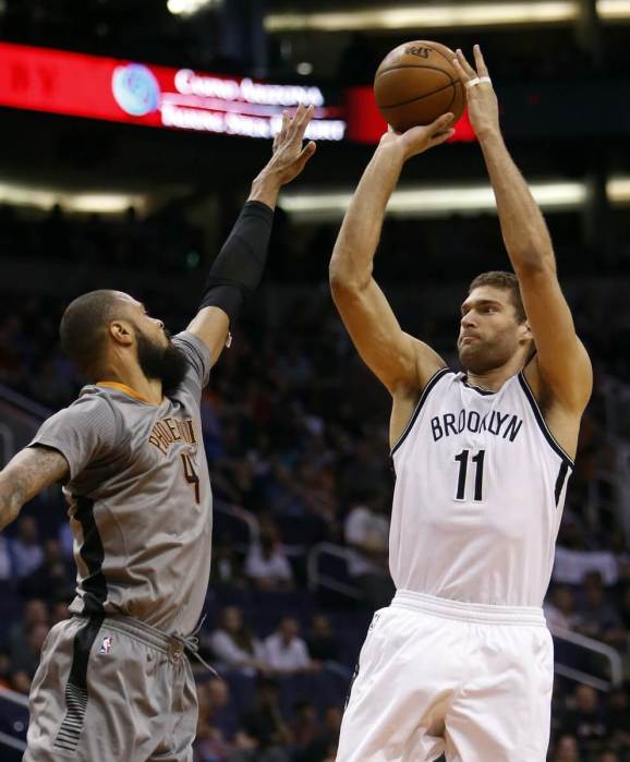 Brooklyn Nets center Brook Lopez (11) shoots over Phoenix Suns center Tyson Chandler in the first quarter during an NBA basketball game, Thursday, Feb. 25, 2016, in Phoenix. (AP Photo/Rick Scuteri)