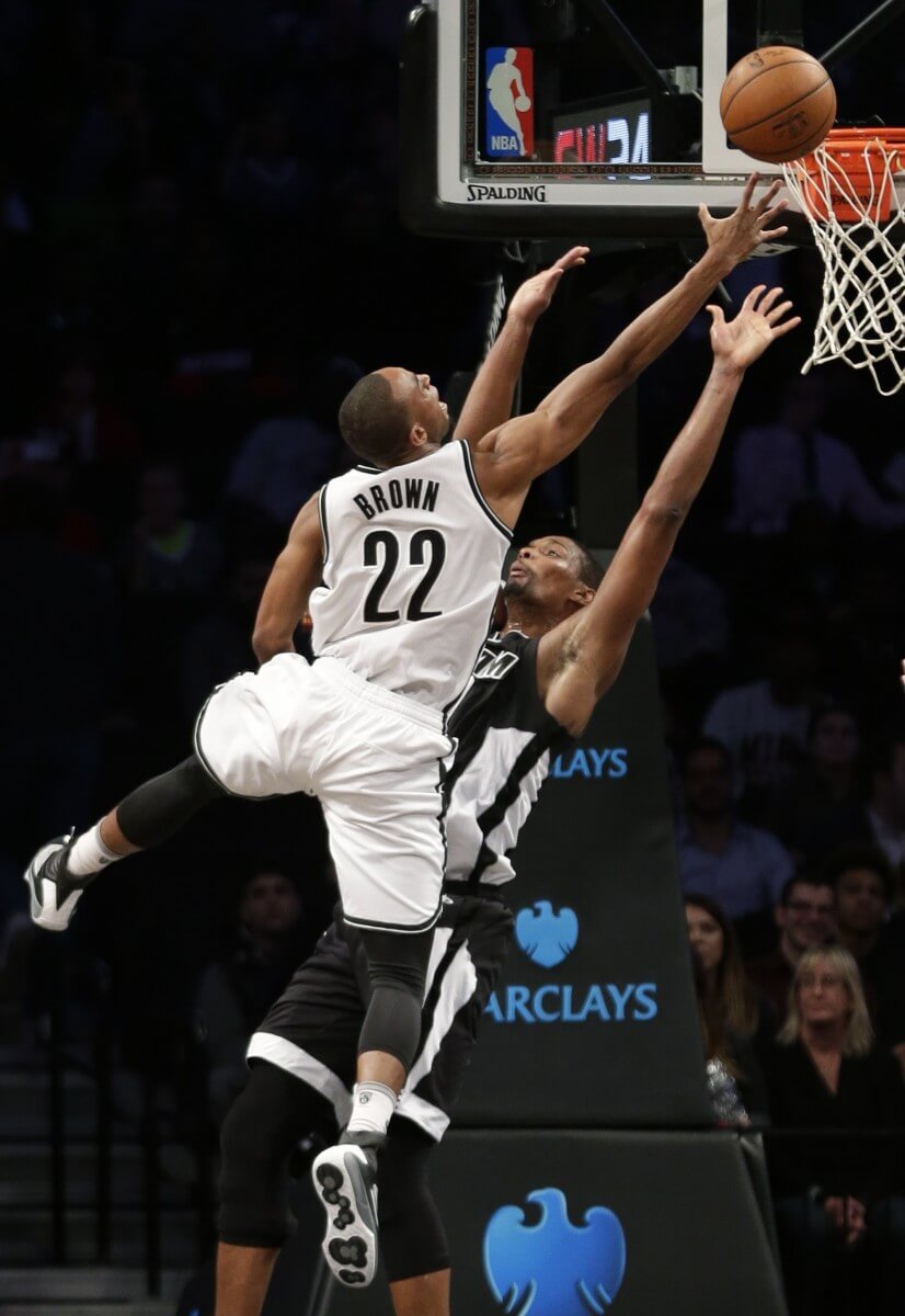Brooklyn Nets' Markel Brown (22) drives past Miami Heat's Chris Bosh (1) during the first half of an NBA basketball game Wednesday, Dec. 16, 2015, in New York. (AP Photo/Frank Franklin II)