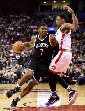 Brooklyn Nets' Joe Johnson (7) drives to the net as Toronto Raptors' DeMar DeRozan defends during first half NBA basketball action in Toronto, Monday, Jan. 18, 2016. (Frank Gunn/The Canadian Press via AP) MANDATORY CREDIT