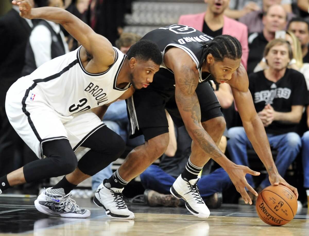 Kawhi Leonard (right) & the Spurs were just too much for Thaddeus Young & the Nets. (AP)