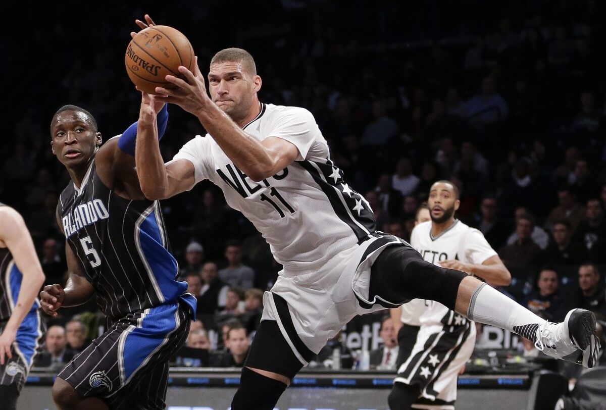 Brooklyn Nets center Brook Lopez (11) and Orlando Magic guard Victor Oladipo (5) fight for a rebound during the third quarter of an NBA basketball game, Friday, Jan. 8, 2016, in New York. The Magic won 83-77. (AP Photo/Julie Jacobson)