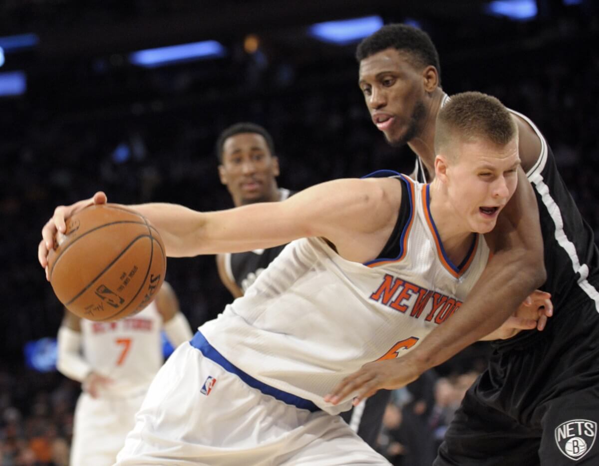 New York Knicks forward Kristaps Porzingis, left, is closely guarded by Thaddeus Young during the fourth quarter. (AP Photo/Bill Kostroun)