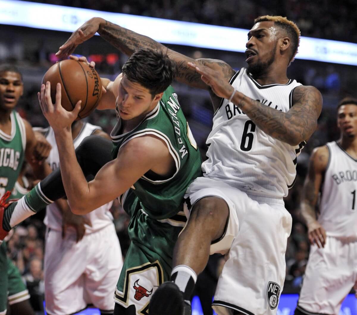 Chicago Bulls' Doug McDermott (3) battles Brooklyn Nets' Sean Kilpatrick (6) for a rebound during the second half of an NBA basketball game Thursday, March 17, 2016, in Chicago. Chicago won 118-102. (AP Photo/Paul Beaty)