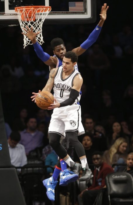 Shane Larkin (0) passes the ball away from Philadelphia 76ers' Nerlens Noel (4) during the first half of an NBA basketball game Thursday, Dec. 10, 2015, in New York. (AP Photo/Frank Franklin II)