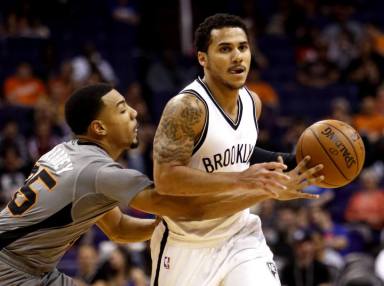 Phoenix Suns guard Phil Pressey (25) reaches for the ball on Brooklyn Nets guard Shane Larkin in the second quarter during an NBA basketball game, Thursday, Feb. 25, 2016, in Phoenix. (AP Photo/Rick Scuteri)