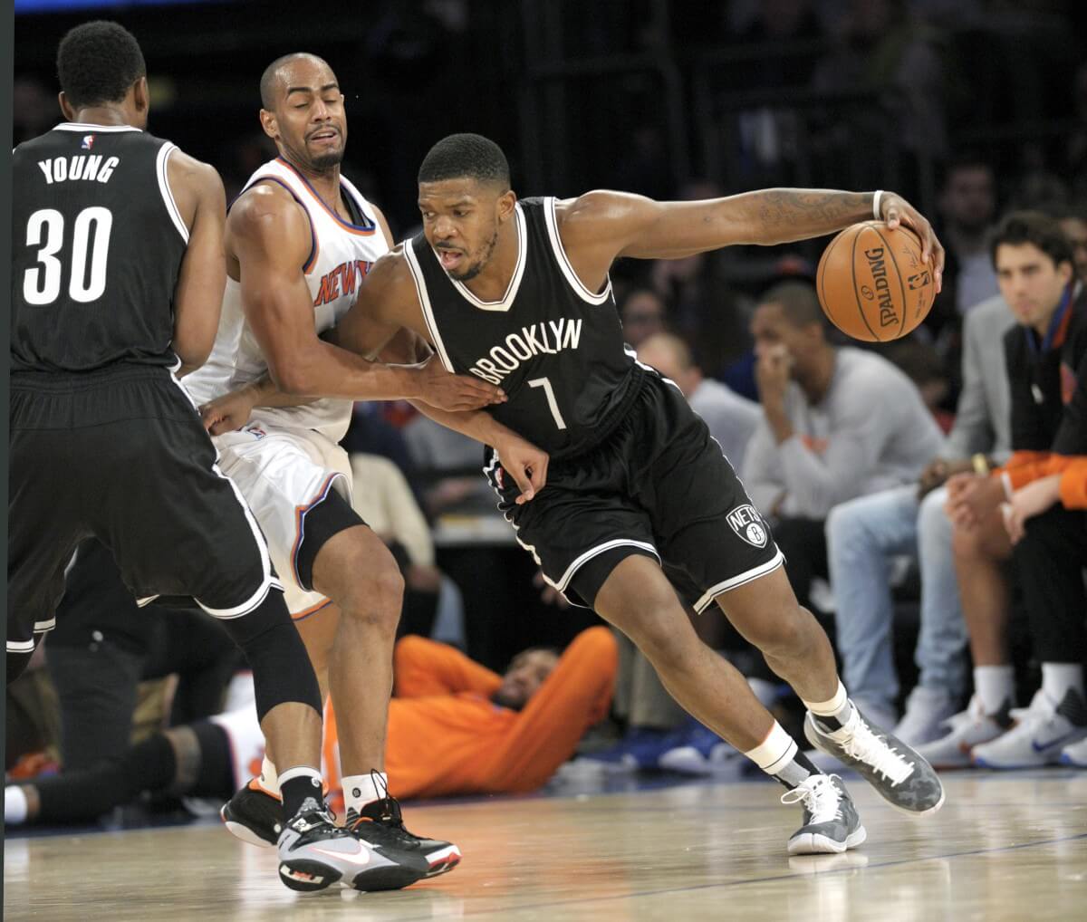 New York Knicks guard Arron Afflalo runs into a pick set by Thaddeus Young (30) as Afflalo guards Nets guard Joe Johnson (7) during the third quarter. The Knicks defeat the Nets 108-91. (AP Photo/Bill Kostroun)