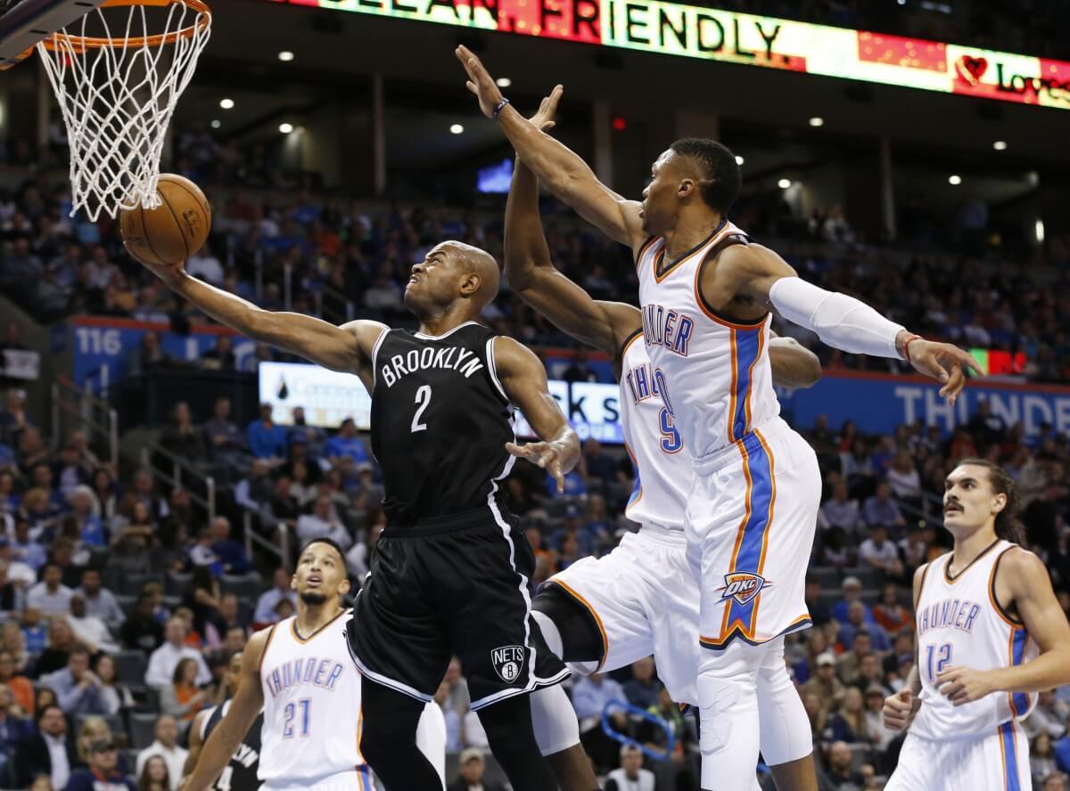 Jarrett Jack shoots in front of Russell Westbrook during the second quarter. (AP Photo/Sue Ogrocki)