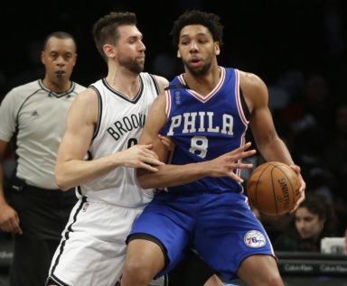 Andrea Bargnani (9) defends Philadelphia 76ers' Jahlil Okafor (8) during the second half of an NBA basketball game Thursday, Dec. 10, 2015, in New York. The Nets won 100-91. (AP Photo/Frank Franklin II)