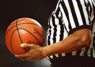 Referee holding basketball